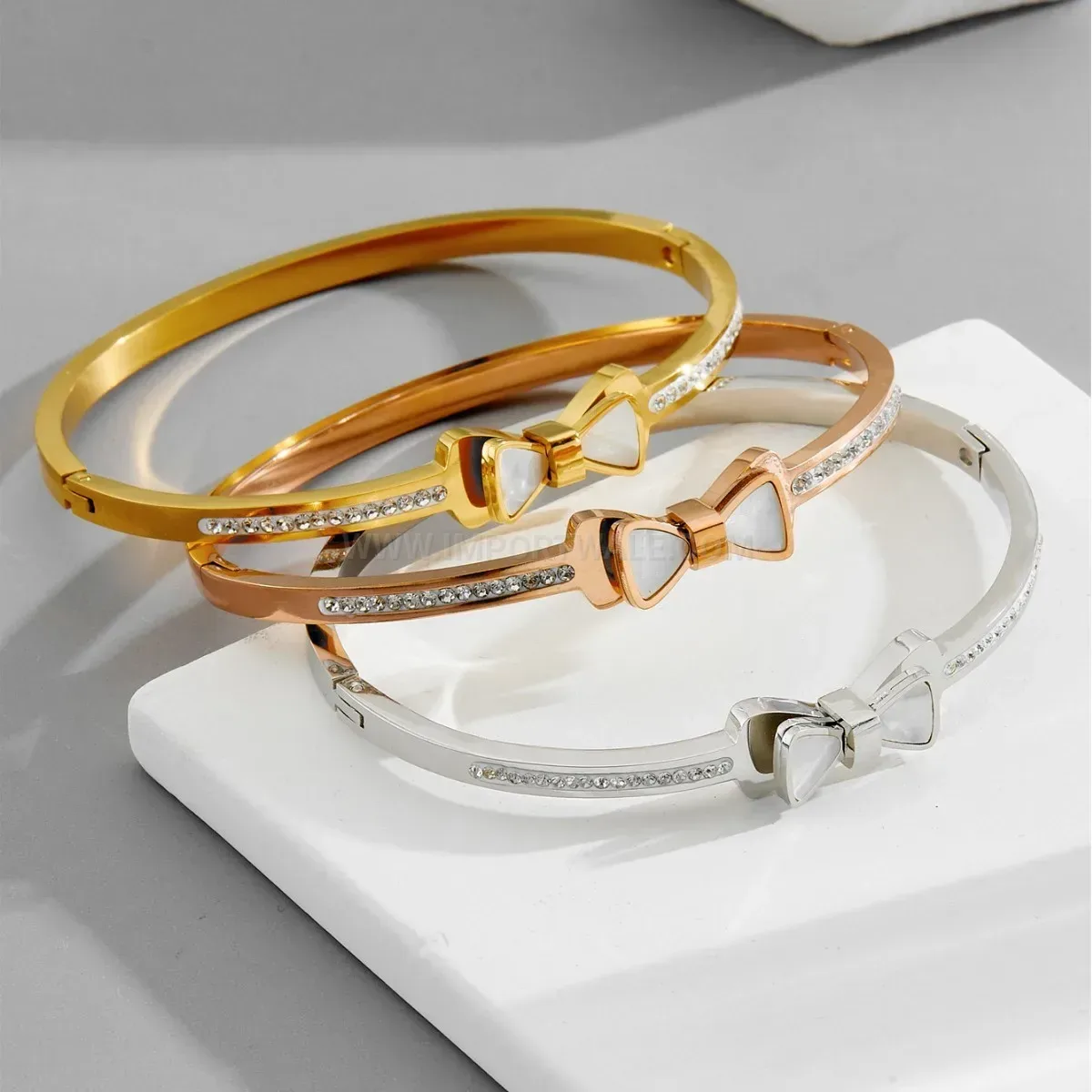 Classic Faux Shell Bow Accent Titanium Steel Clasp Bangle