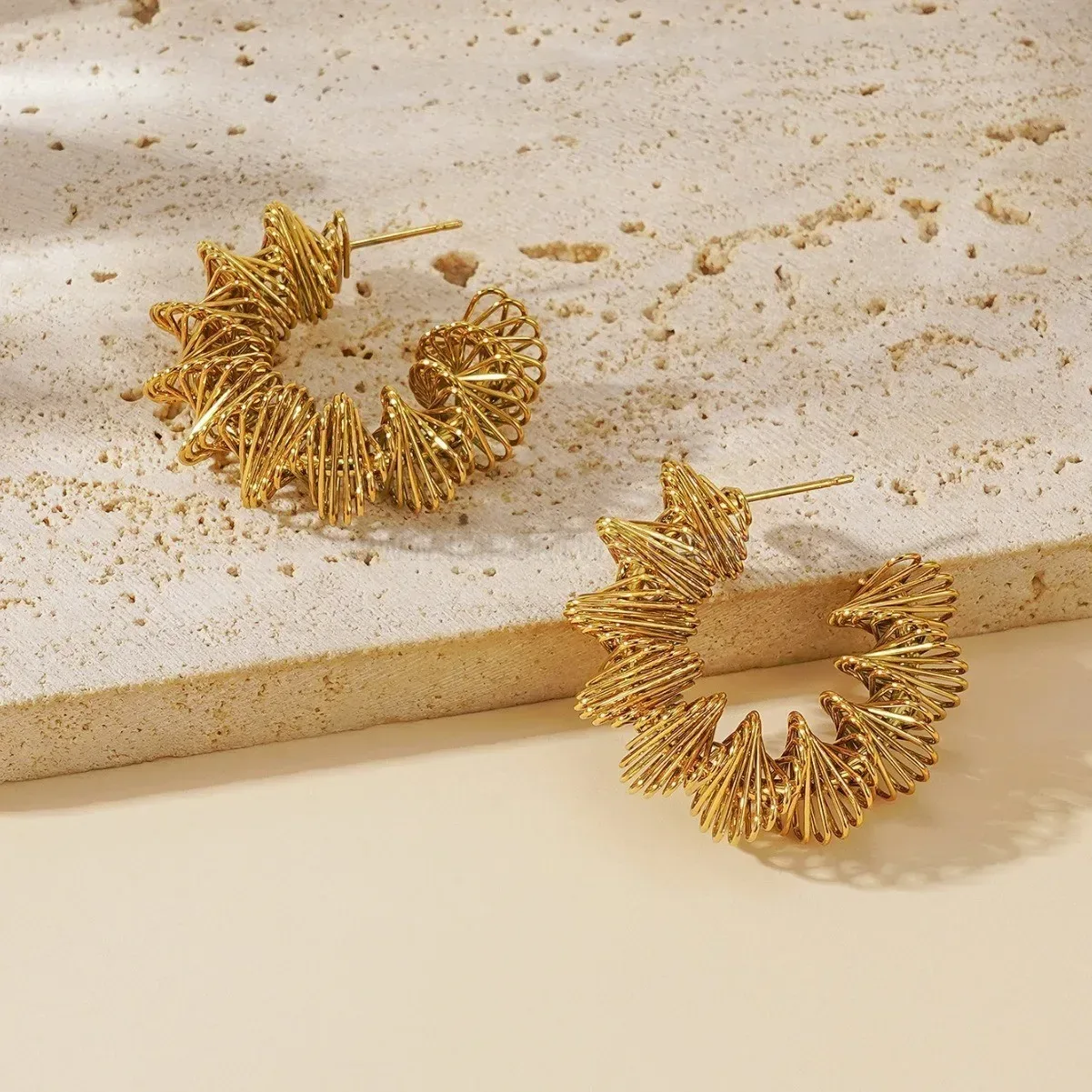 Chic Hollow Twisted Spring Hoop Earrings in Gold Titanium Steel